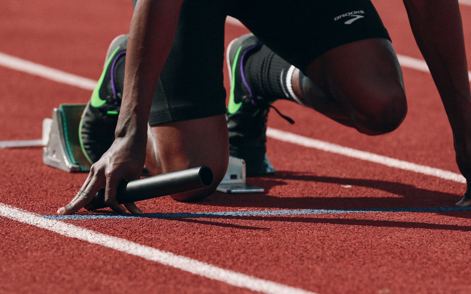 Runner at a track start line preparing to race